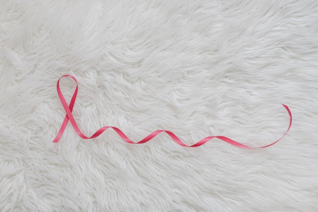 breast cancer pink ribbon, on a mat of white color.